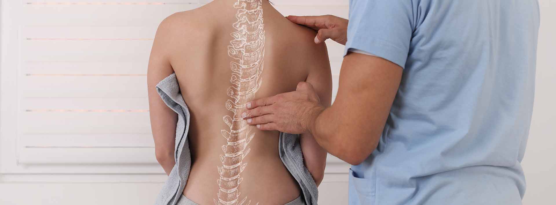 woman with scoliosis examined by physical therapist