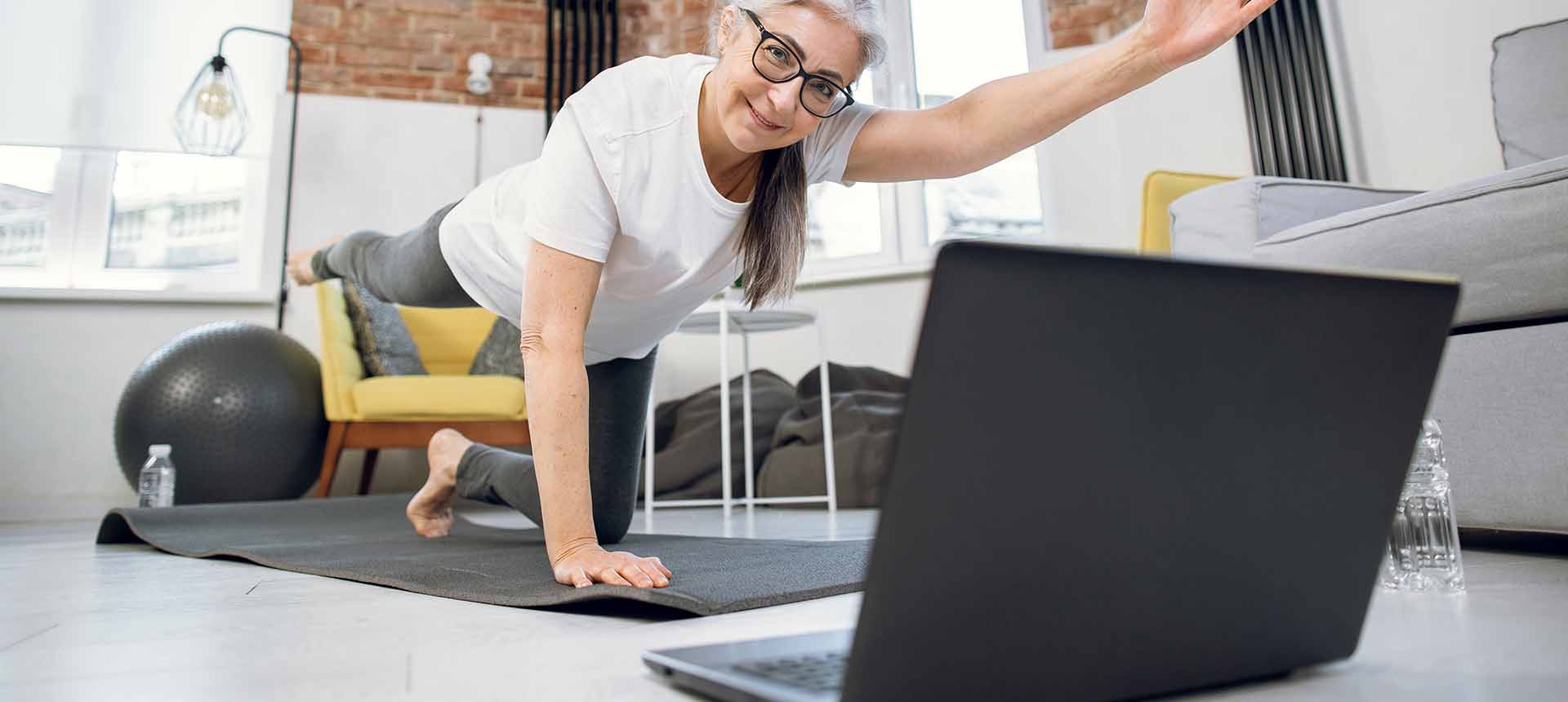 woman doing on line physical therapy in front of notebook
